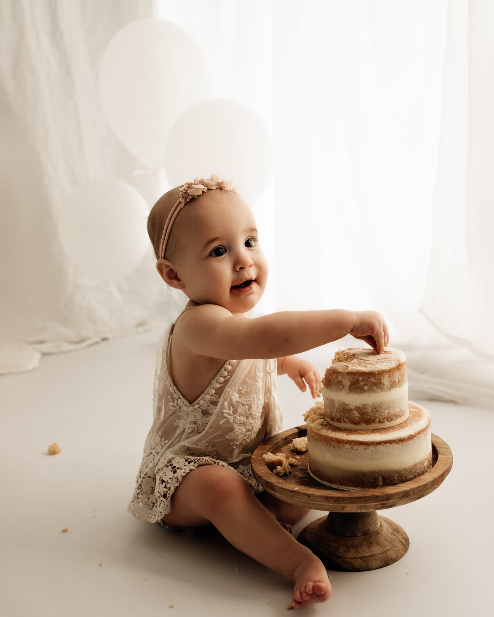 baby girl smiling during their bradford cake smash photoshoot