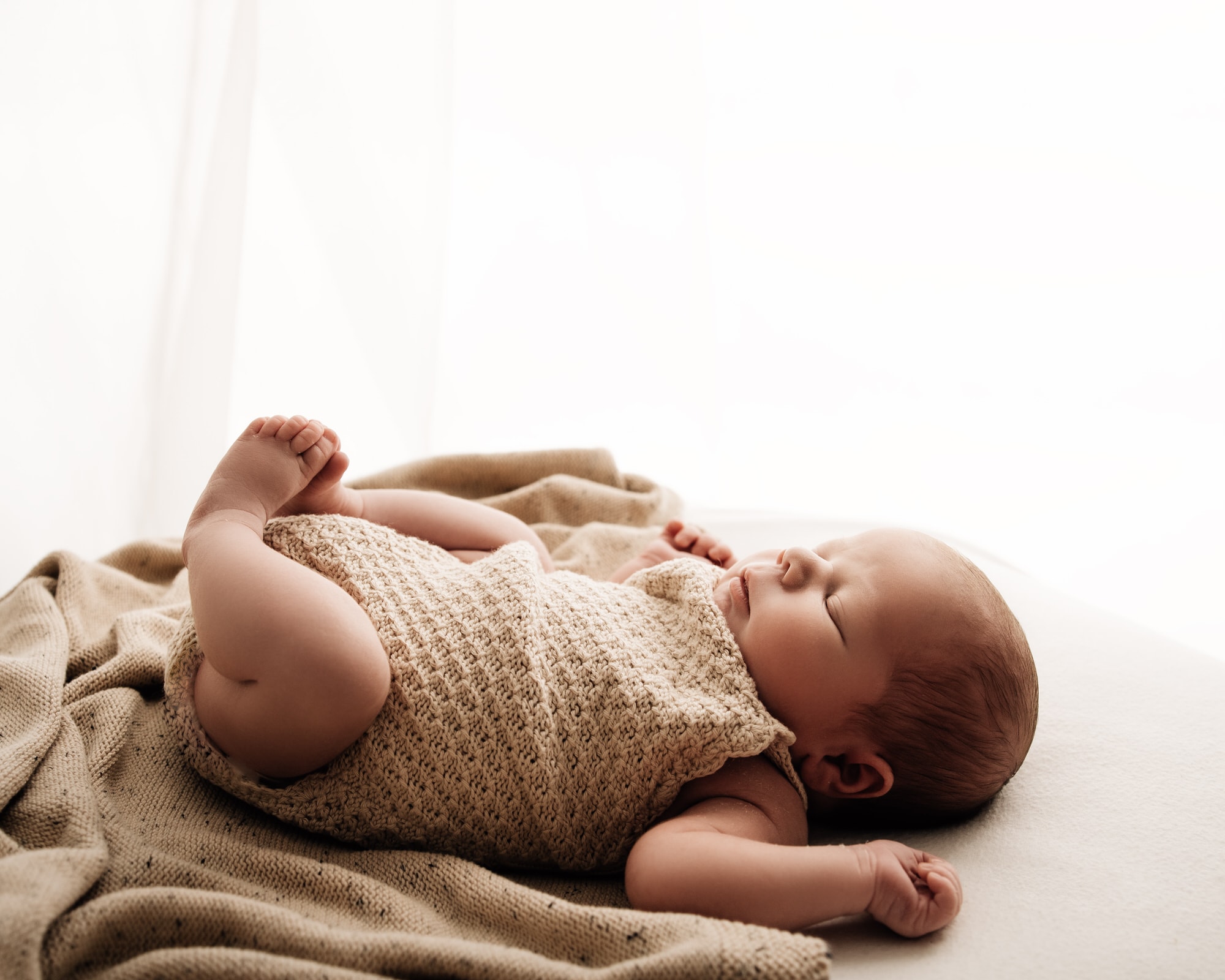 baby lading down during a leeds newborn photographer photoshoot