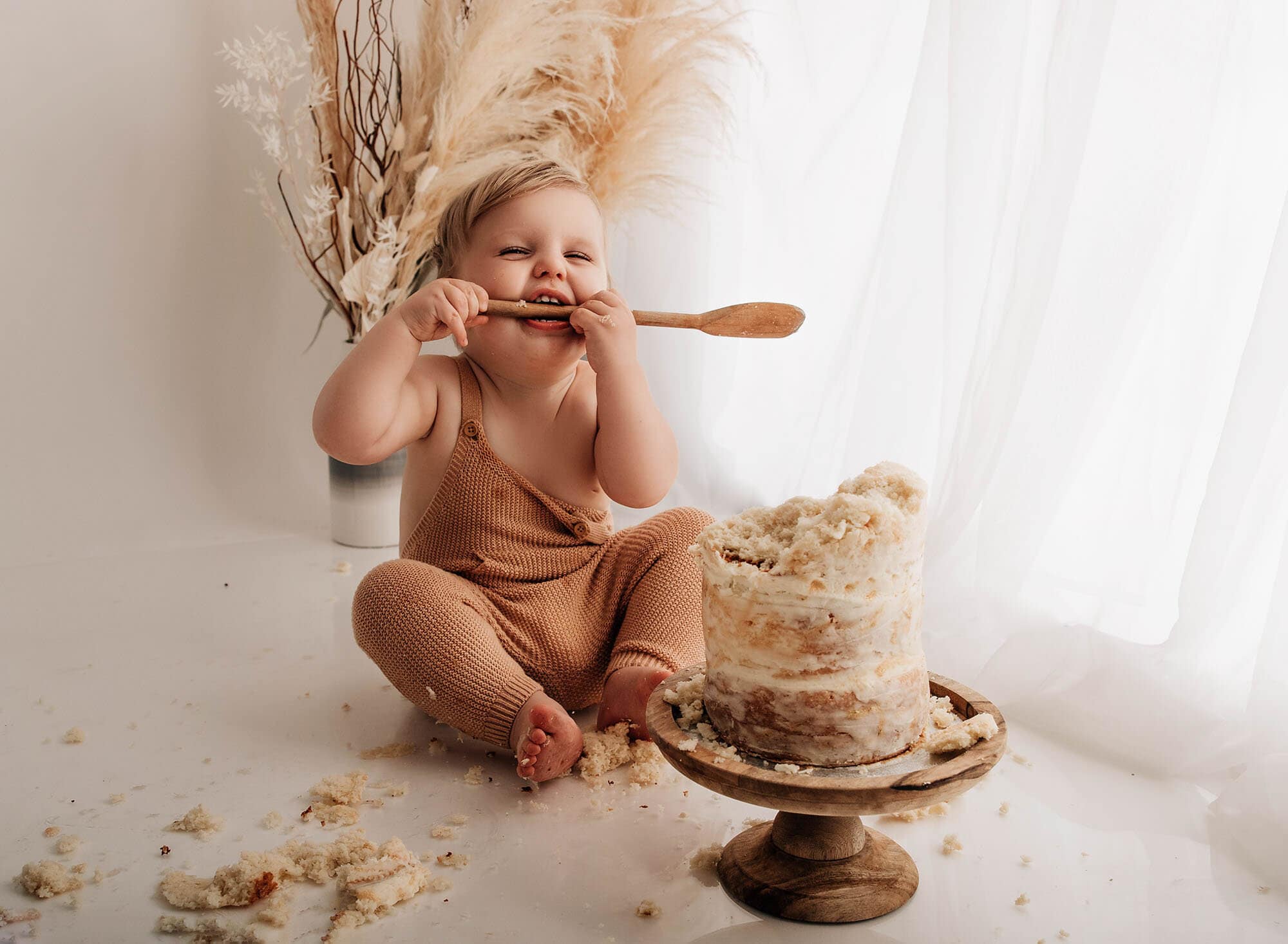 baby chewing a spoon at a bradford cake smash photographer shoot