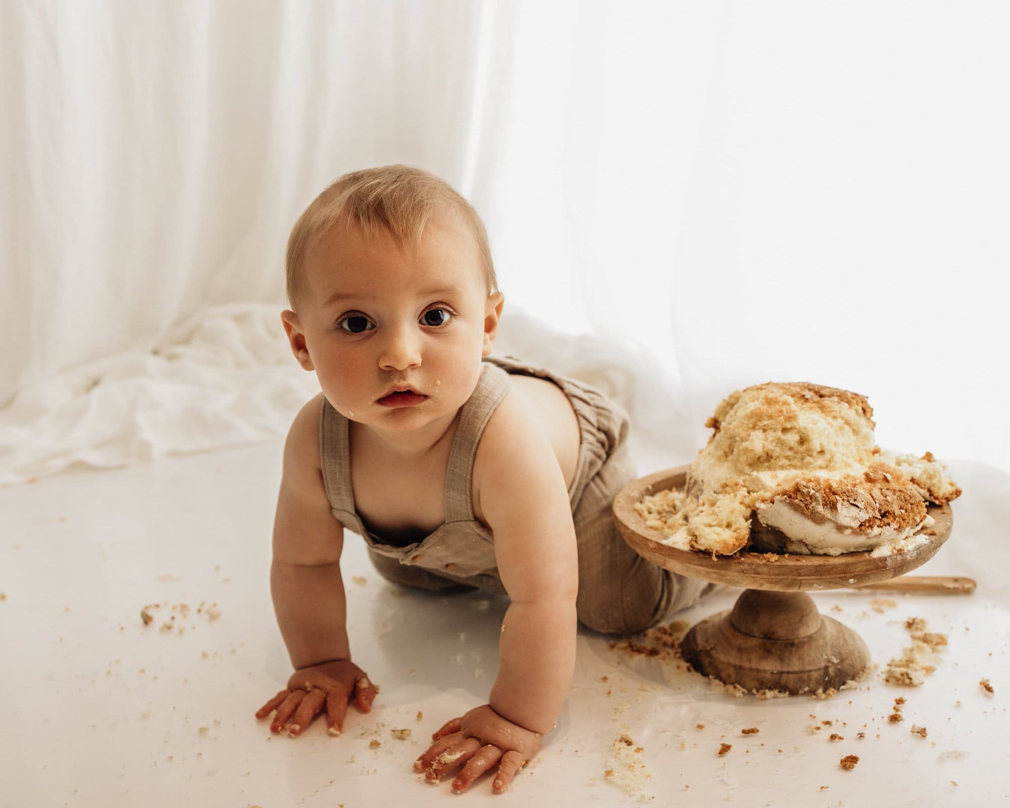 baby with cake during a bradford cake smash photoshoot