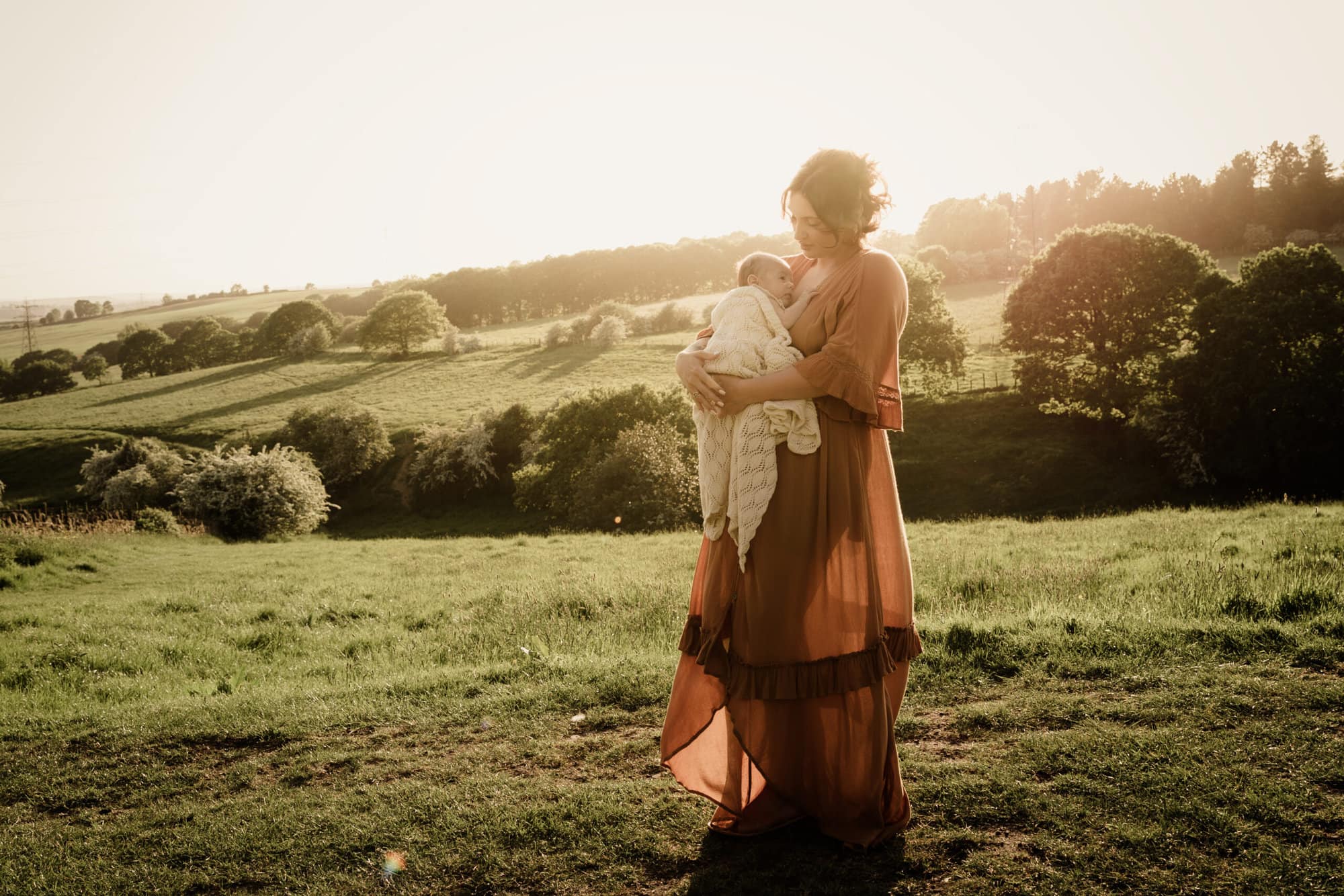 Mother holding baby during a photoshoot in a leeds family photographer shoot